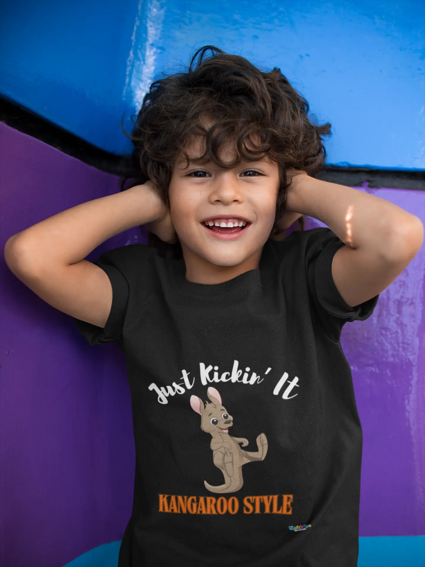 Child wearing a Culzzles vibe premium black t-shirt with a kangaroo graphic and text, posing against a colorful background.