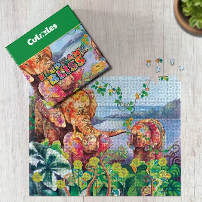 Jigsaw puzzle with elephants and foliage on a wooden surface, featuring the 'Coluzzles' brand.