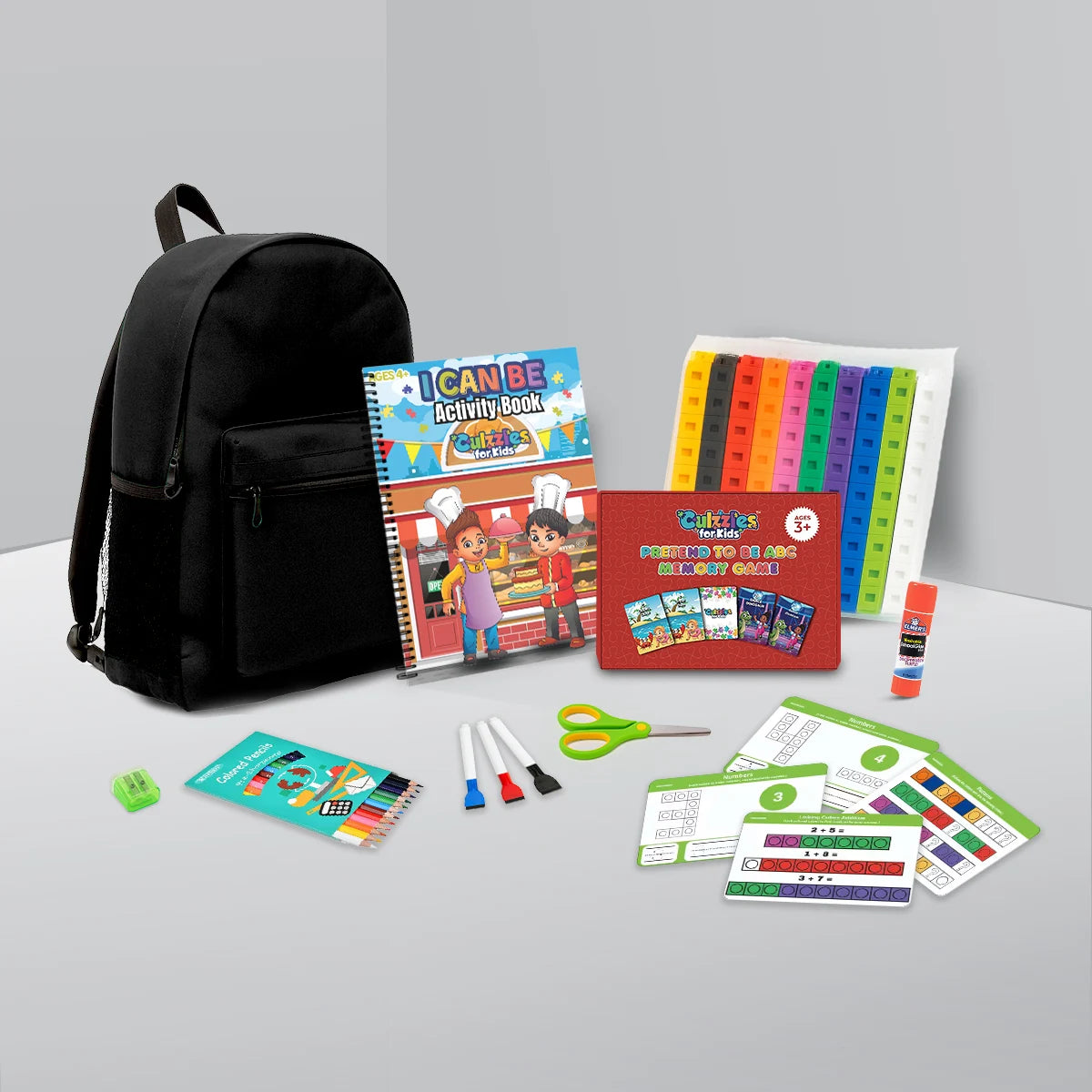 Backpack and educational materials including books and stationery on a gray surface.